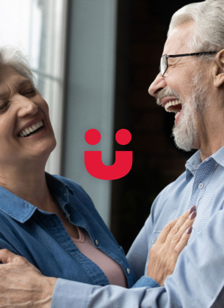 Couple laughing with perfectly repaired dentures.