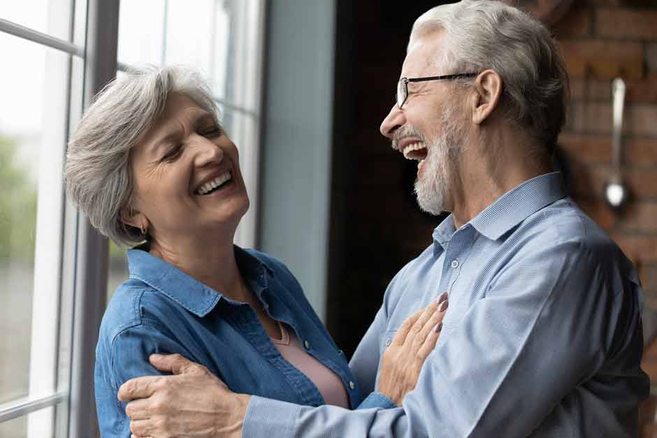 An older couple comfortable in their dentures